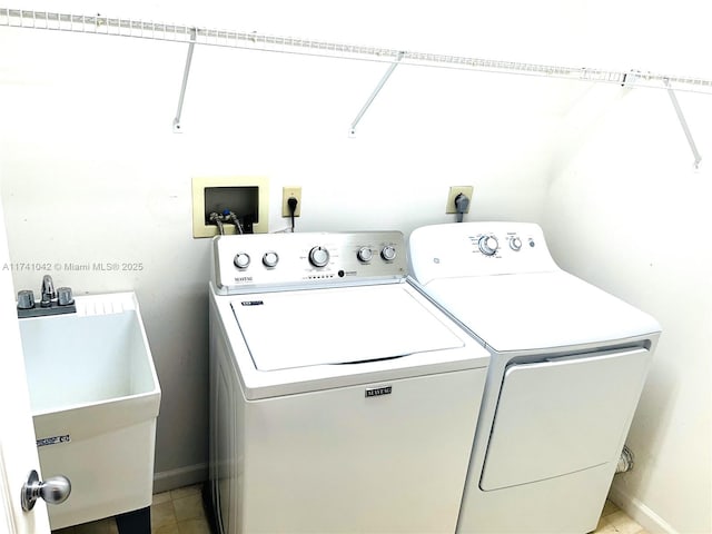 washroom with sink and washing machine and dryer