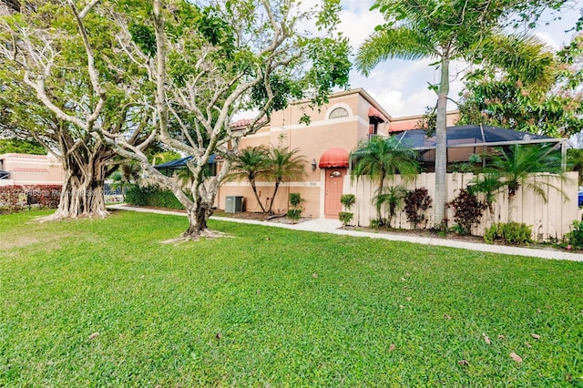 view of yard featuring central AC unit and a lanai