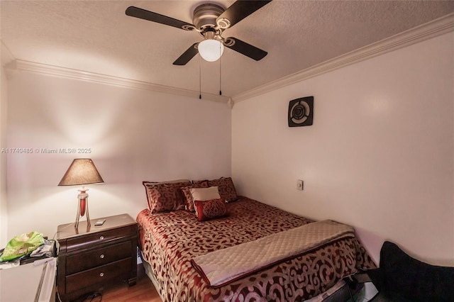 bedroom featuring ceiling fan, crown molding, light hardwood / wood-style flooring, and a textured ceiling