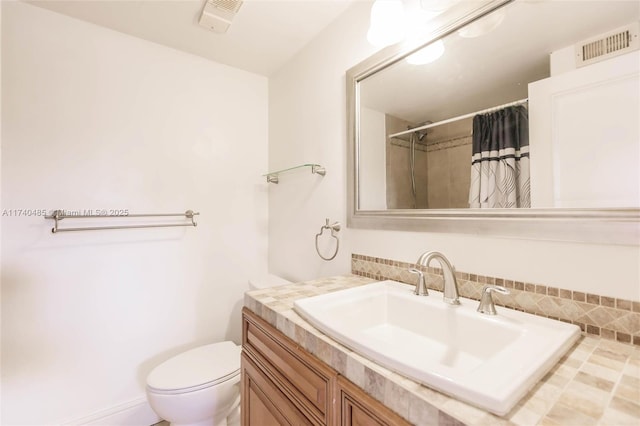 bathroom with vanity, toilet, and a shower with shower curtain