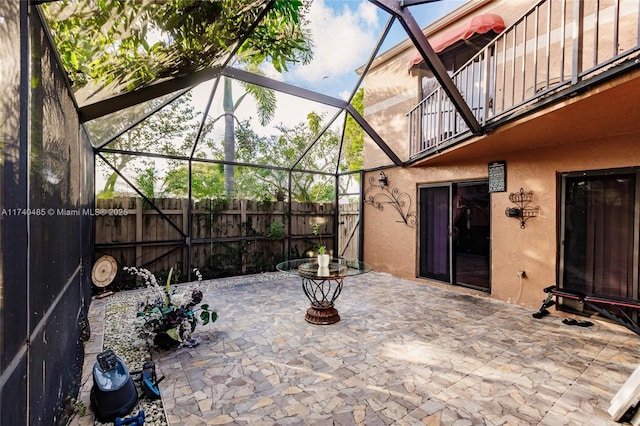 view of patio / terrace with a lanai and a balcony