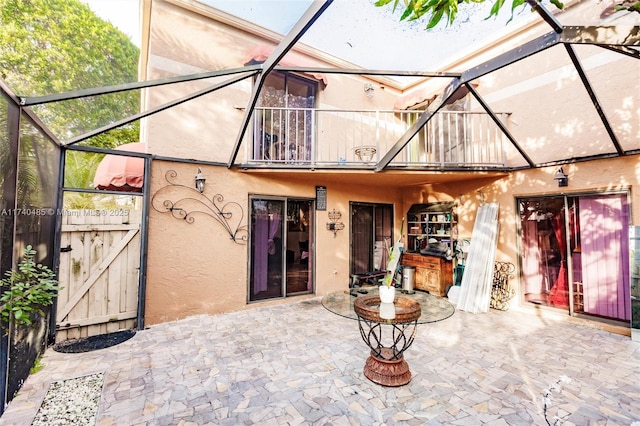 exterior space with a balcony and glass enclosure