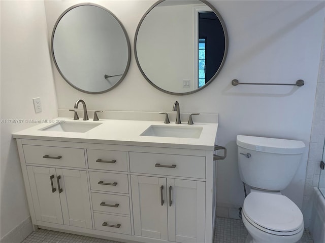 bathroom featuring vanity, tile patterned floors, and toilet