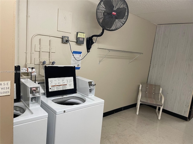 washroom with wooden walls and washer and dryer