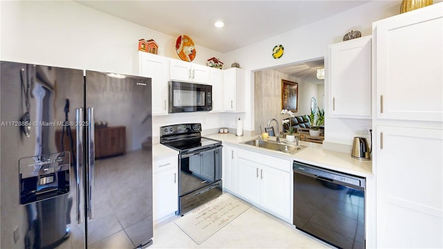 kitchen with white cabinetry, light tile patterned floors, sink, and black appliances