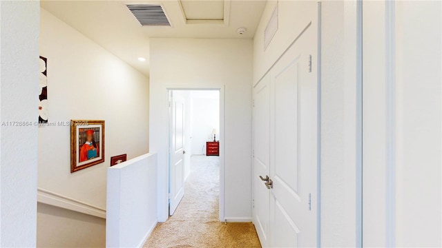 corridor featuring light colored carpet
