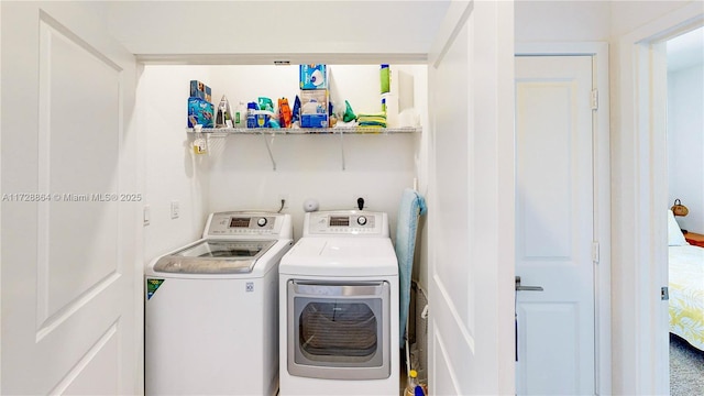 clothes washing area featuring washer and clothes dryer