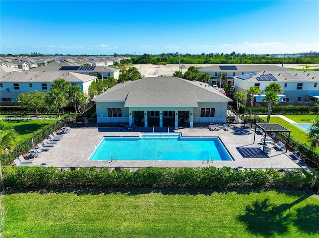view of pool with a patio area and a lawn