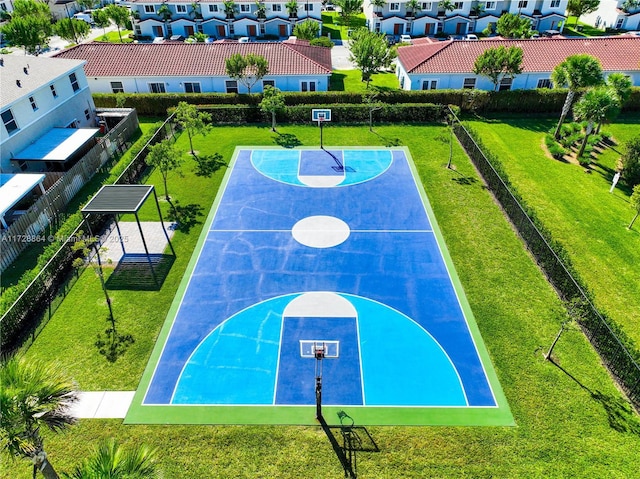 view of basketball court with a lawn