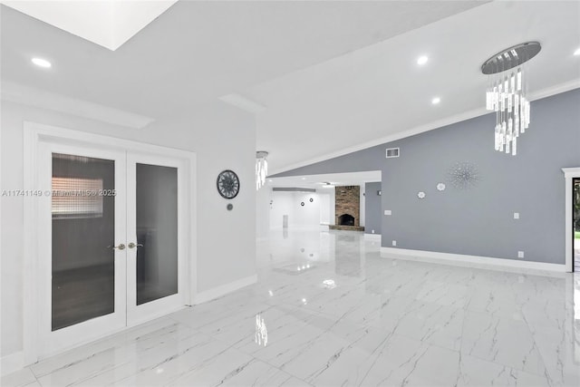 11965 SW 15th Ct, Davie, FL 33325 - unfurnished room with baseboards, marble finish flooring, a large fireplace, french doors, and recessed lighting