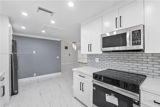 11965 SW 15th Ct, Davie, FL 33325 - kitchen featuring stainless steel microwave, range with electric stovetop, baseboards, crown molding, and white cabinets