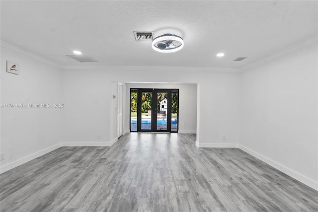 11965 SW 15th Ct, Davie, FL 33325 - unfurnished room with crown molding, baseboards, recessed lighting, wood finished floors, and french doors
