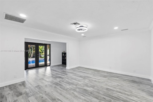 11965 SW 15th Ct, Davie, FL 33325 - spare room with ornamental molding, french doors, wood finished floors, baseboards, and recessed lighting