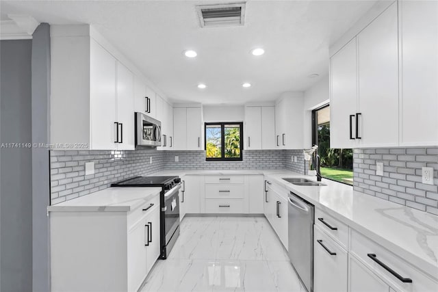 11965 SW 15th Ct, Davie, FL 33325 - kitchen featuring stainless steel appliances, light marble finish flooring, recessed lighting, a sink, and light stone countertops