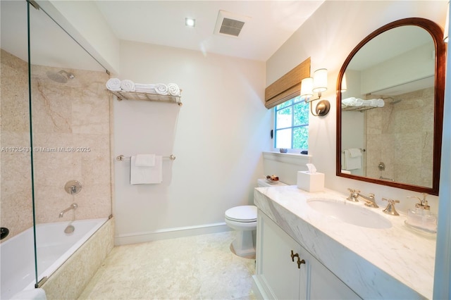 full bathroom featuring toilet, vanity, and tiled shower / bath combo