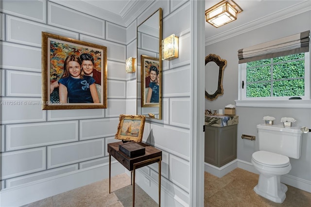 bathroom featuring crown molding and toilet