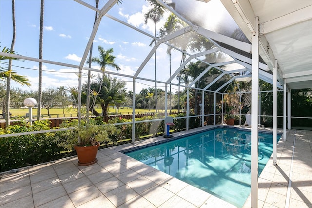 view of pool featuring a patio and glass enclosure