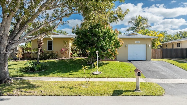 view of front of house with a garage and a front lawn