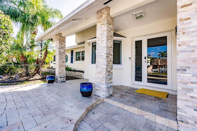 property entrance featuring a patio area