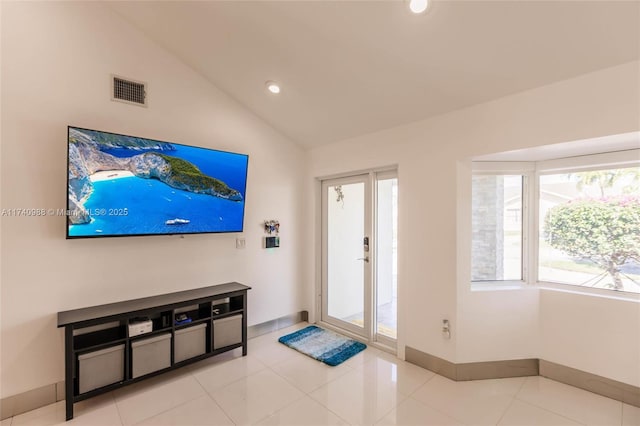 foyer entrance with lofted ceiling and light tile patterned floors