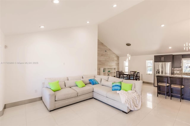 living room featuring vaulted ceiling and light tile patterned floors