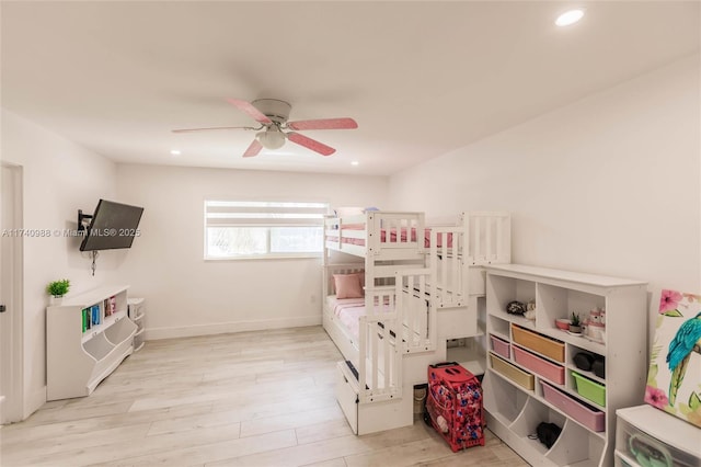 bedroom with ceiling fan and light hardwood / wood-style floors