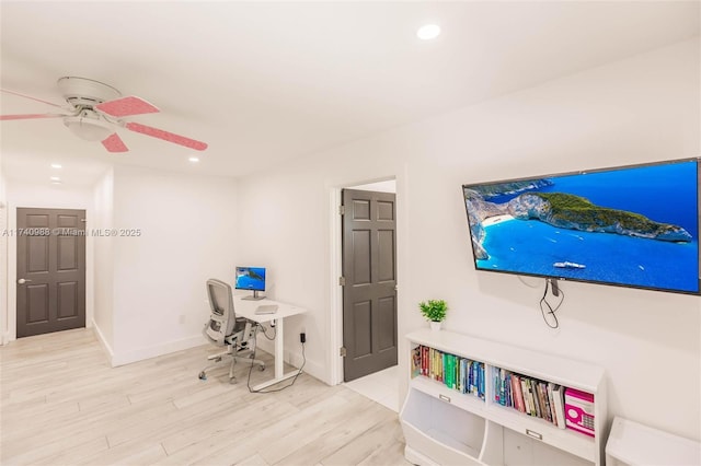 office with ceiling fan and light hardwood / wood-style flooring