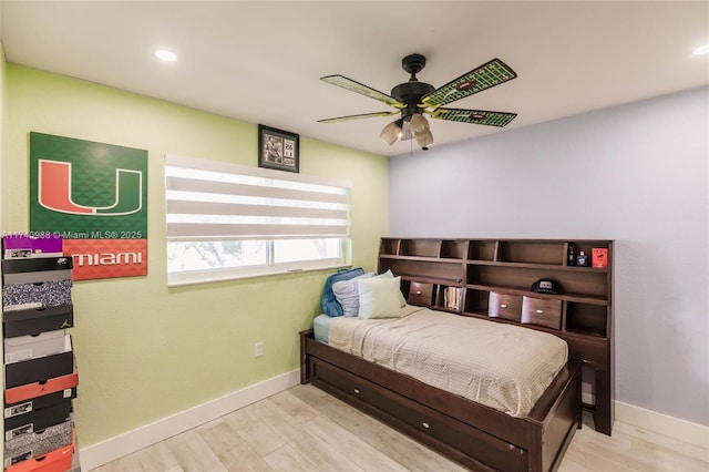 bedroom with ceiling fan and light hardwood / wood-style floors