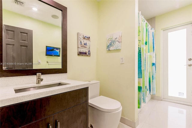 bathroom with vanity and toilet