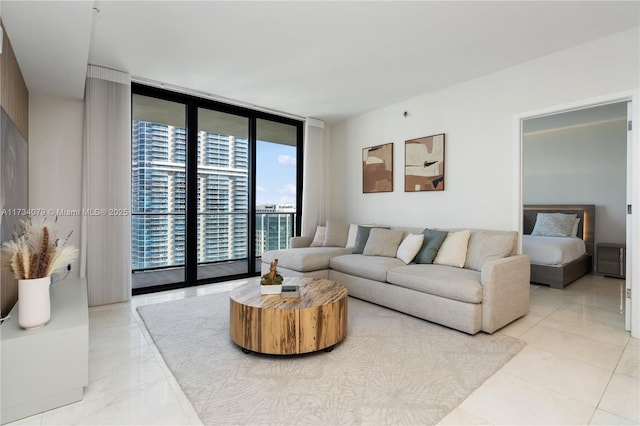 living room with a wall of windows and light tile patterned floors