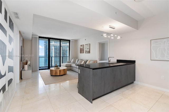 tiled living room with floor to ceiling windows and sink