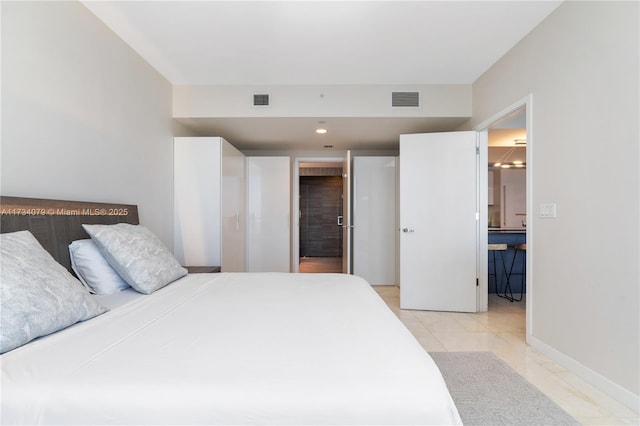 tiled bedroom featuring connected bathroom