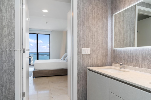 bathroom featuring a water view, vanity, and tile patterned flooring