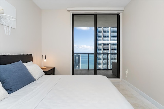 bedroom with floor to ceiling windows and access to exterior