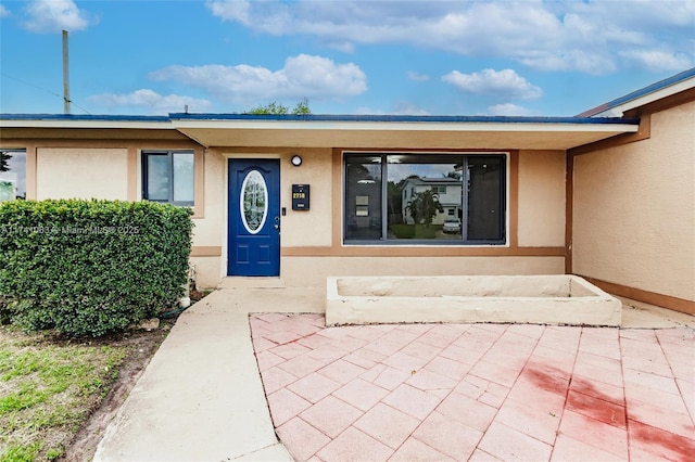 property entrance with a patio area