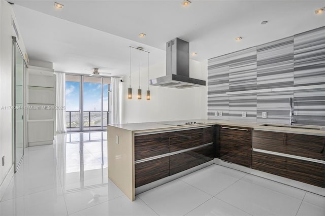 kitchen featuring floor to ceiling windows, sink, island range hood, light tile patterned floors, and black electric stovetop