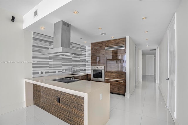 kitchen featuring light tile patterned flooring, sink, island range hood, black electric stovetop, and oven