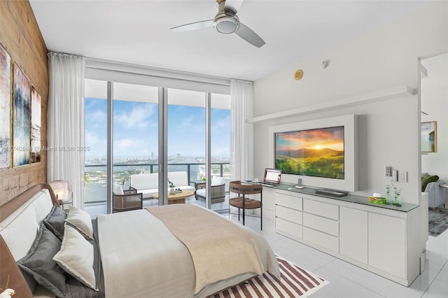 bedroom featuring ceiling fan, a wall of windows, and light tile patterned floors