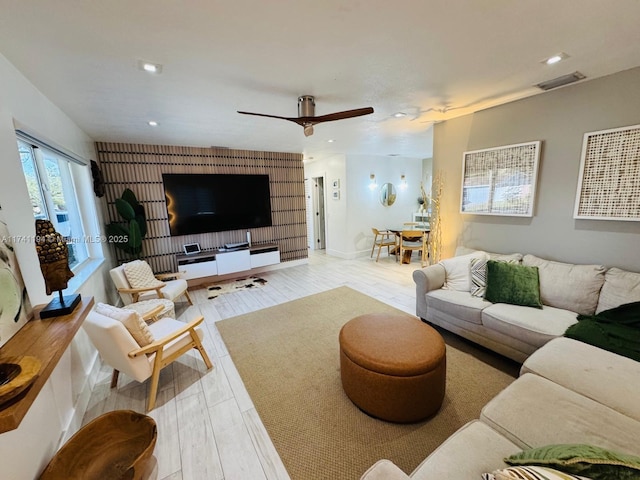 living room featuring light hardwood / wood-style flooring and ceiling fan