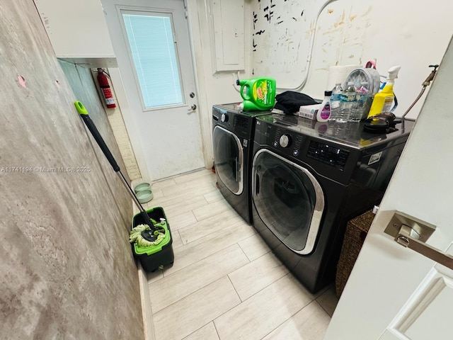 laundry area featuring electric panel and washer and dryer