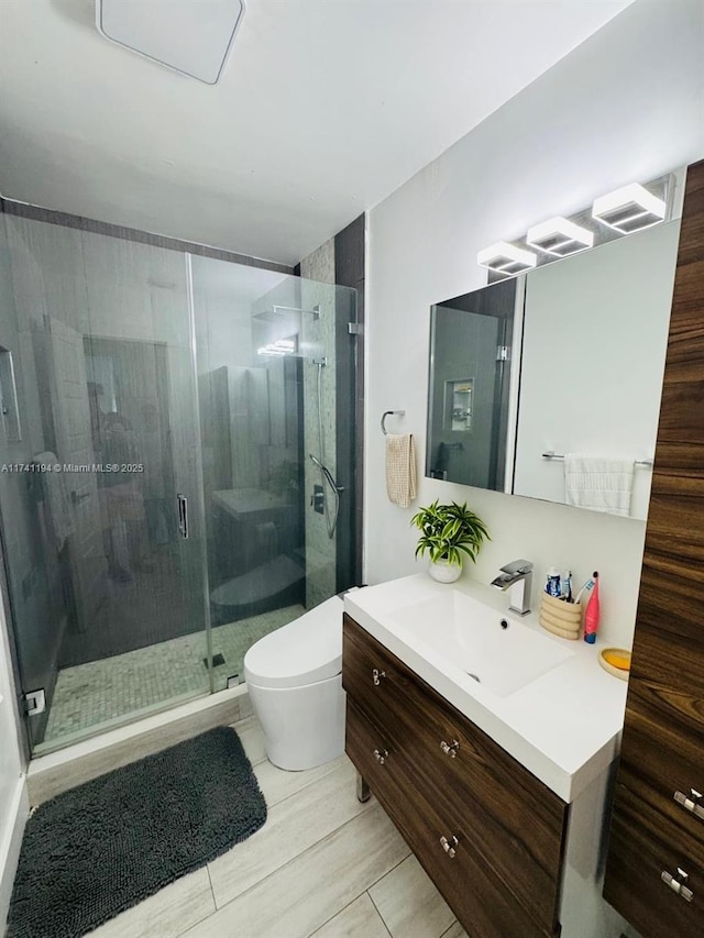 bathroom with vanity, toilet, and walk in shower