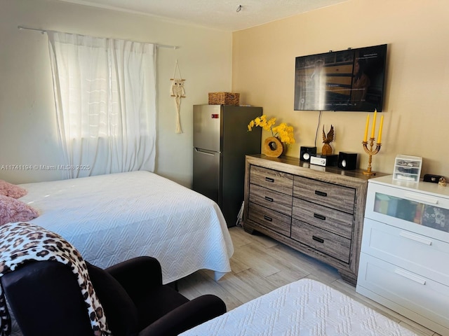 bedroom featuring stainless steel fridge