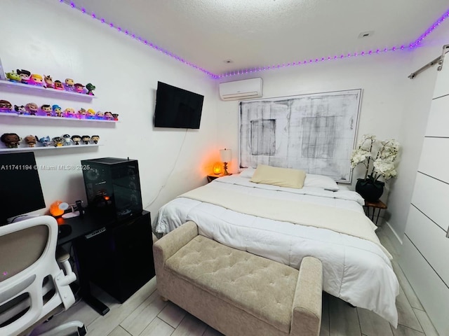 bedroom featuring a textured ceiling and an AC wall unit