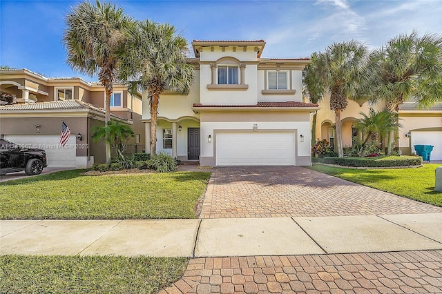 mediterranean / spanish-style home with a garage and a front yard