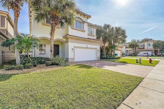 view of front facade with a garage and a front lawn