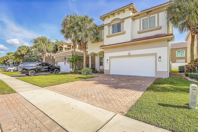 mediterranean / spanish-style home with a garage and a front yard