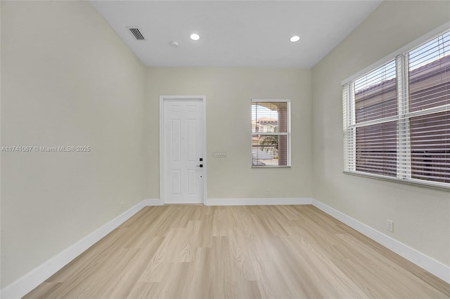 spare room featuring light wood-type flooring