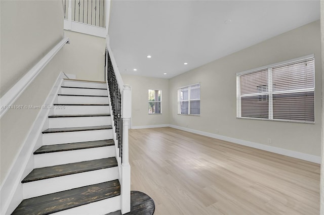 stairs featuring hardwood / wood-style flooring