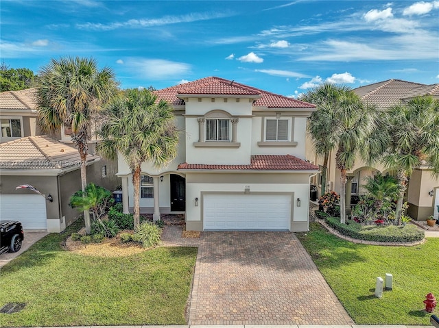 mediterranean / spanish home with a garage and a front yard