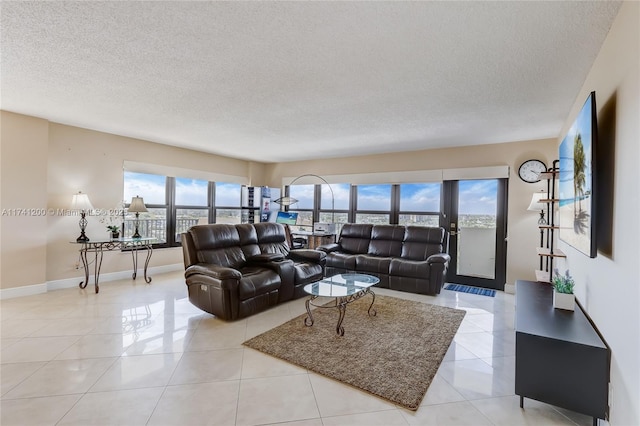 tiled living room featuring a textured ceiling